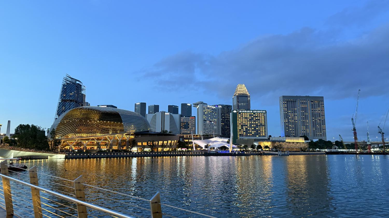Singapore skyline across Marina Bay at dusk