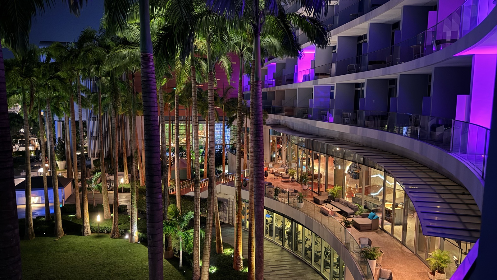 The palm-lined swimming pool at W Singapore — Sentosa Cove, viewed from above